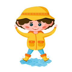A cute boy in a yellow jacket and rubber boots jumps through puddles.