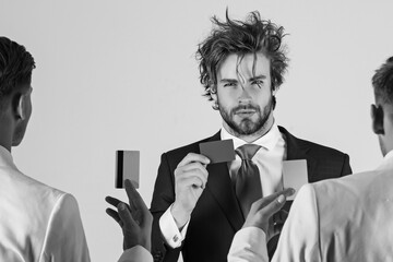 Group of business people facing each other. Business ethics concept. Businessmen exchanging cards on grey background.