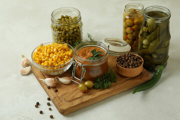 Different pickled food and ingredients on white textured table