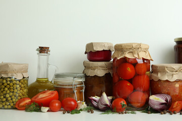 Different pickled food and ingredients on white background
