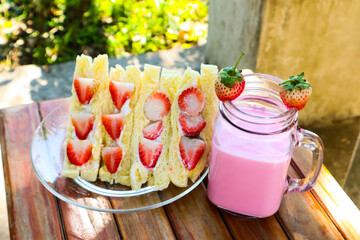 Strawberry cream sandwich with strawberry milk.