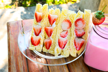 Strawberry cream sandwich with strawberry milk.
