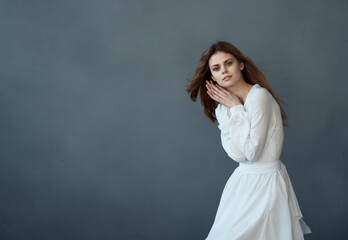 Fototapeta premium Beautiful woman in white dress glamor and luxury elegant style gray background