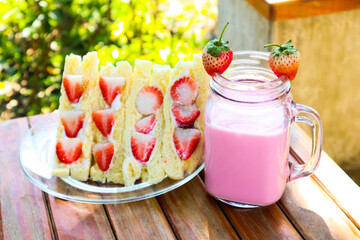Strawberry cream sandwich with strawberry milk.