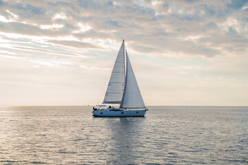 Fototapeta na wymiar Sailboat in the sea in the sunset, luxury summer adventure, in Mediterranean sea, Europe