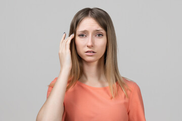 Fototapeta premium Concerned, frustrated young blond girl feeling fatigue, as suffer pain in head, painful headache or migraine
