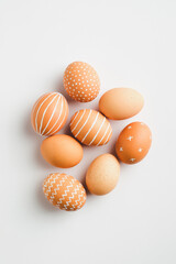 Modern Easter eggs on white background. Flat lay, top view. Simple, nordic style.