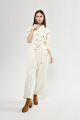 pretty woman in white suit trendy brown full length boots
