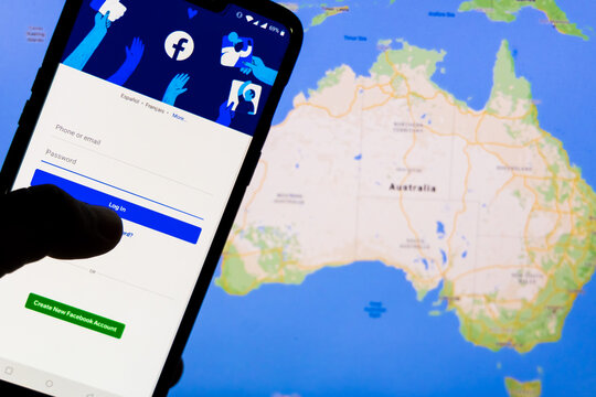 Smartphone with Facebook's login screen against the map of Australia in the background. Facebook recently blocked users in Australia from sharing News articles on the platform.