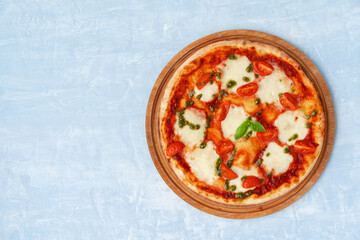 Top view of pizza Margherita on gray surface