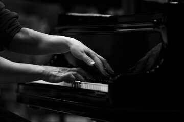 Hands of a woman playing the piano close up in black and white © furtseff