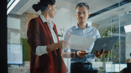 CEO and Chief Executive Talking About Company Business Growth, Consult Data Analysis and Use Laptop Computer. Two Professionals Discussing Revenue Increase, Market Disruption, Planning Strategy