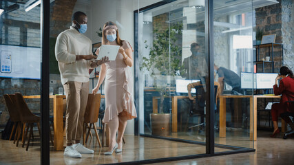 CEO and Chief Executive Wearing Face Masks Talking About Company Business Growth, Analyze Data, Use Laptop Computer. Two Professionals Discussing Revenue Increase, Market Disruption, Planning Strategy