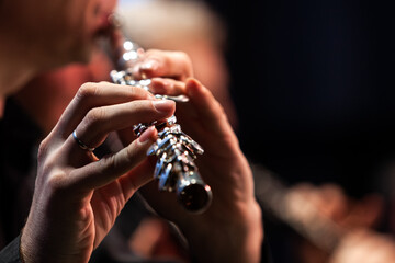  Hands of a musician playing the flute close up  - 414880836