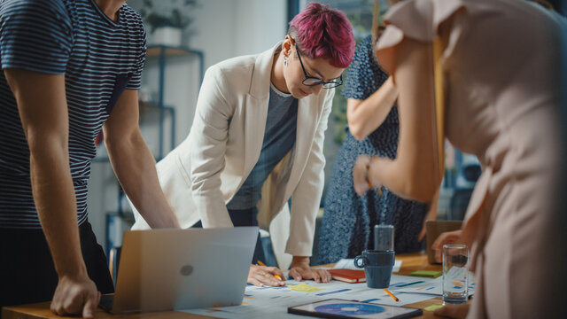 Diverse Multi-Ethnic Team of Professional Businesspeople Meeting in the Modern Office Conference Room. Creative Team Around Table Discuss Data Analysis, Plan Marketing Compain, Social Media Strategy