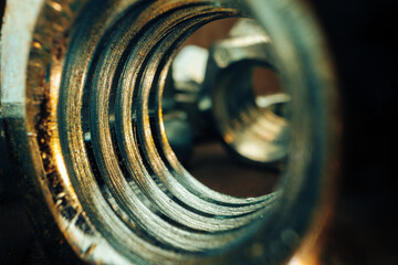 Macro shot of metal nuts on textured surface