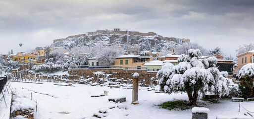 Panorama of the ruins of the Roman Agora underneath the Acropolis of Athens, Greece, with thick snow and ice during a winter storm