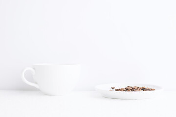 Empty cup of coffee on white background with coffee beans.