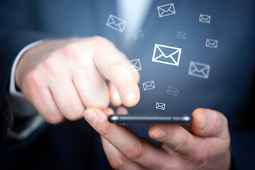 Email concept with person using a smartphone or tablet.
