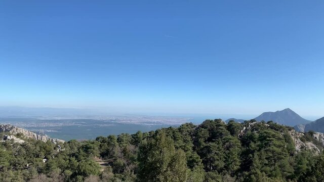 Panoramic view of konyaalti, Lara, coast of Antalya and Mediterranean sea from high Mountain in gulluk dagi park. Can see very far on a sunny day 
