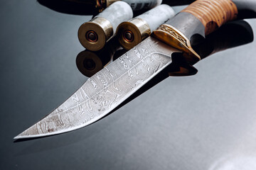 Hunting knife on black background with reflection