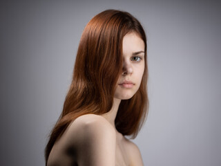 portrait of a woman red hair naked shoulders side view