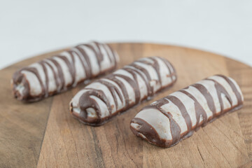 Delicious chocolate bars on a wooden table