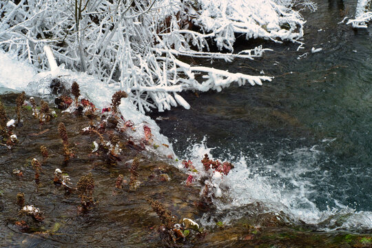 Picnic area of frozen Grza waterfall and lake - beauty of winter nature of Serbia