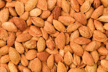 Pile of almonds close-up as background.
