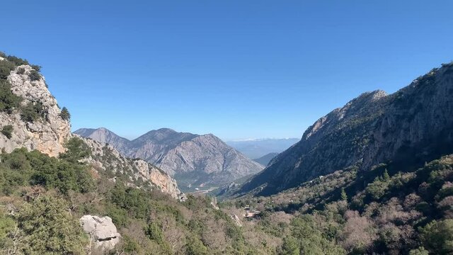 Panoramic view of mountains and Termessos hamam at gulluk dagi national park in Turkey. Camera moves from left to right