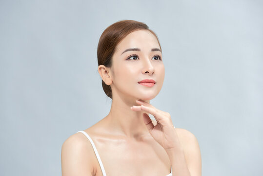 Beautiful asian woman with perfect makeup and smooth skin isolated on color background. Facial Beauty plastic surgery concept.