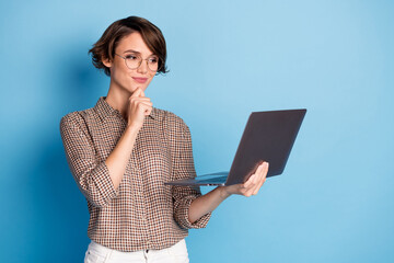 Photo of minded charming young woman hold hand chin laptop businesswoman isolated on blue color...
