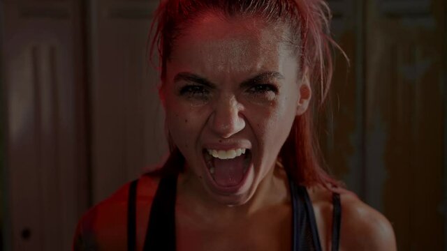 Exhausted athletic young female with sweat face scream furiously in anger after exhausting gym workout. 4K video