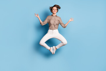 Obraz premium Full size photo of pretty calm woman jump up air make om sign relax isolated on pastel blue color background