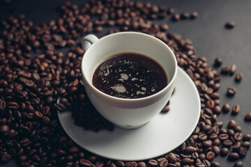 coffee beans drink aroma and white saucer cup gray background