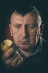 Man is eating an apple. Delicious, juicy, common and healthy fruit. The Forbidden fruit.
