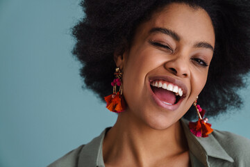 Close up of a cheerful young attractive woman grimacing