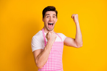 Photo of delighted person open mouth scream yeah fists up celebrate triumph isolated on yellow color background