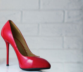 Red high-heeled shoes. Women's shoes with heels. A pair of women's red patent leather shoes on a...