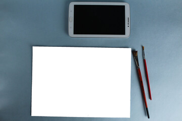 online training drawing tablet and sheet of white paper with a pattern on a light blue background with a mock up and a place for text