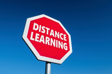 Stop traffic sign with DISTANCE LEARNING text to cease coronavirus precautions keeping children at home