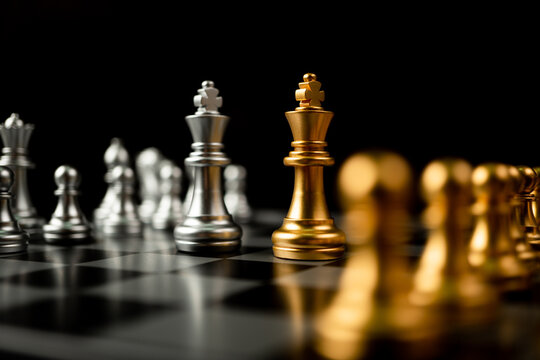 Golden and silver Chess king pieces Invite face to face and There are chess pieces in the background. Concept of competing, leadership and business vision for a win in business games
