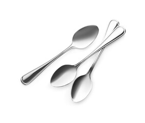 Clean shiny metal spoons on white background, top view