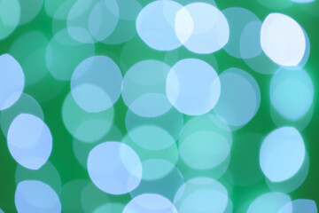 Blurred view of beautiful lights on green background