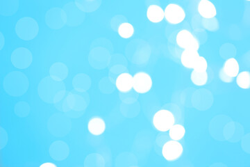 Beautiful blurred lights on cyan background, bokeh effect