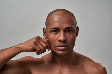 Man sliding his finger on tender skin of a cheek