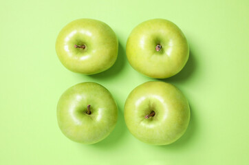 Fresh ripe apples on green background, flat lay