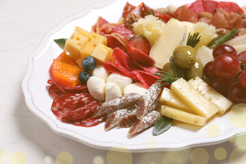 Plate full of assorted appetizers on white table, closeup