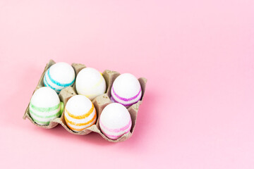 Fototapeta na wymiar Colorful Easter eggs on a pink background. Copy space. Celebrating Easter