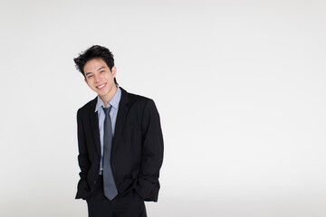 Young and handsome healthy Asian woman with a friendly smiley face and positive happy pose on a plain background. Concept for joy, proud, self-confident, and successful male in business and life